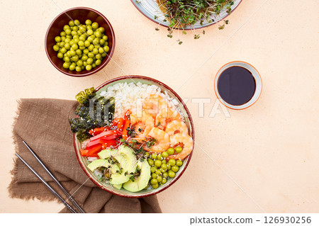A poke bowl with shrimp, avocado, pepper, green peace and micro greens A poke bowl with shrimp, avocado, pepper, green peace and micro greens 126930256