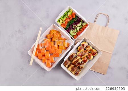 Sushi set and poke bowl with trout, avocado and vegetables. Sushi set and poke bowl with trout, avocado and vegetables. 126930303