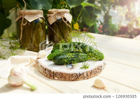 Pickled cucumbers in a jar, fresh cucumbers, herbs, garlic and dill for canning Pickled cucumbers in a jar, fresh cucumbers, herbs, garlic and dill for canning 126930385