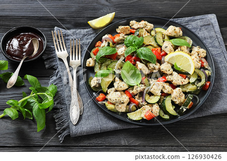 baked italian chicken and vegetables on a plate baked italian chicken and vegetables on a plate 126930426