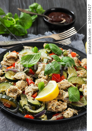 baked italian chicken and vegetables on a plate baked italian chicken and vegetables on a plate 126930427