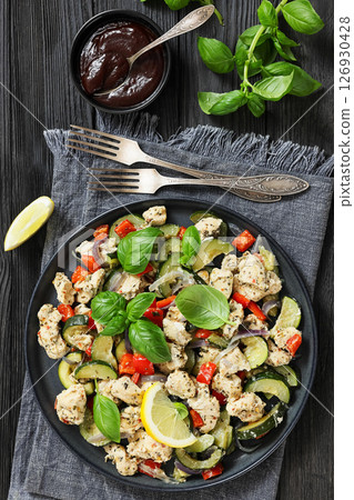 baked italian chicken and vegetables on a plate 126930428