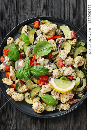 baked italian chicken and vegetables on a plate baked italian chicken and vegetables on a plate 126930431