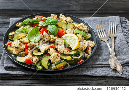 baked italian chicken and vegetables on a plate 126930432