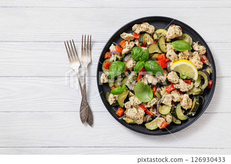 baked italian chicken and vegetables on a plate baked italian chicken and vegetables on a plate 126930433