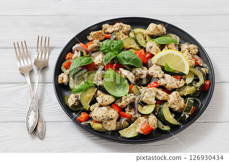 baked italian chicken and vegetables on a plate baked italian chicken and vegetables on a plate 126930434