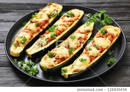 stuffed zucchini boats filled with bolognese sauce 126930436