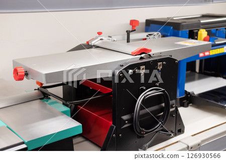 Woodworking machine for precise cuts in a workshop environment located indoors during daylight hours 126930566