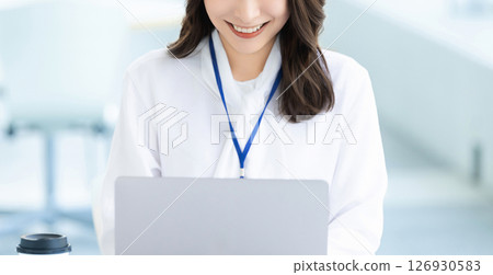 Smiling woman/businesswoman using a laptop Smiling woman/businesswoman using a laptop 126930583