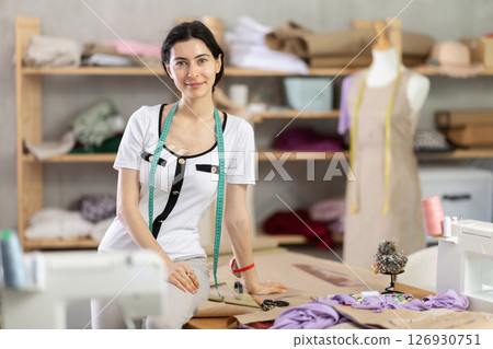 woman dressmaker stands in the workshop woman dressmaker stands in the workshop 126930751