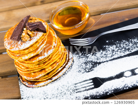 Pancakes with honey and chocolate 126930905
