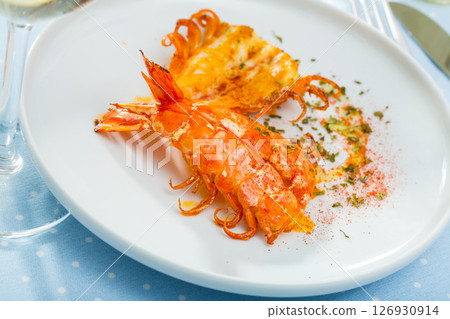 King fried prawns with parsley and spice on a white plate 126930914