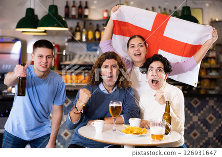 Group of people with England flag toasting with beer, having fun at party in nightclub 126931647