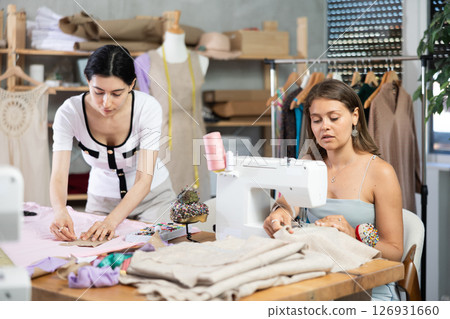 Female dressmakers sewing clothes in the workshop 126931660