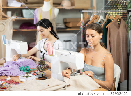 team of dressmakers sewing clothes team of dressmakers sewing clothes 126932401