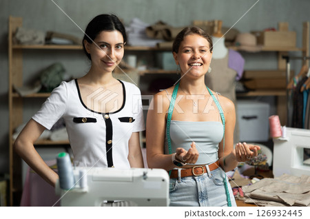 dressmakers are standing in the workshop and smiling dressmakers are standing in the workshop and smiling 126932445