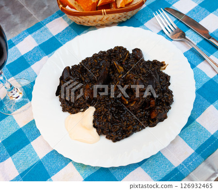Arroz negro - spanish recipe, black paella with cuttlefish on plate 126932465