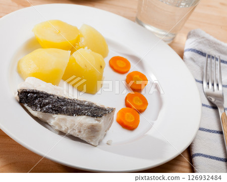 Steamed hake with potatoes and carrot 126932484