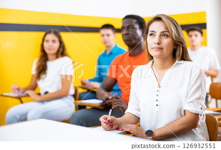 Portrait of attentive students on training session in auditorium Portrait of attentive students on training session in auditorium 126932551