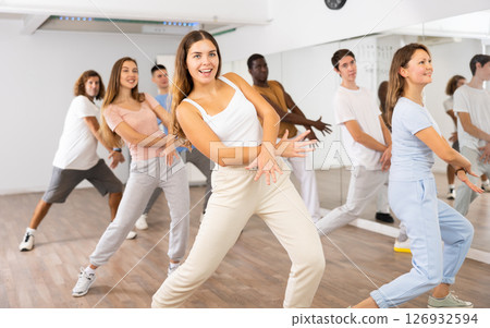 Group of different people rehearsing dance in dance studio 126932594