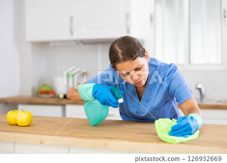 Housewife using rag to wash table 126932669