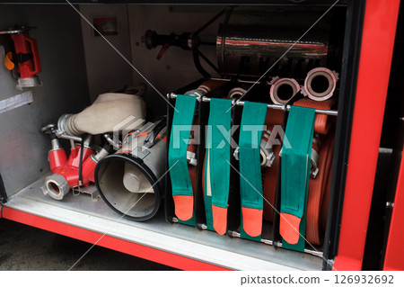 Detailed view of firefighting equipment in action during training exercises at a fire station in an urban area at midday Detailed view of firefighting equipment in action during training exercises at a fire station in an urban area at midday 126932692