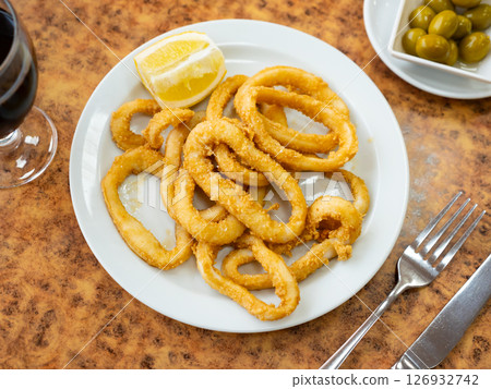 Fried andalusian squid served on plate in restaurant 126932742