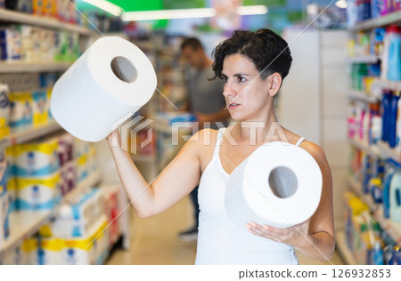Young latin american woman choosing paper towels in supermarket 126932853
