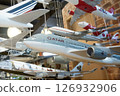 Close-up of collection of model airplanes hanging from the ceiling for decorate in a cafe. 126932906