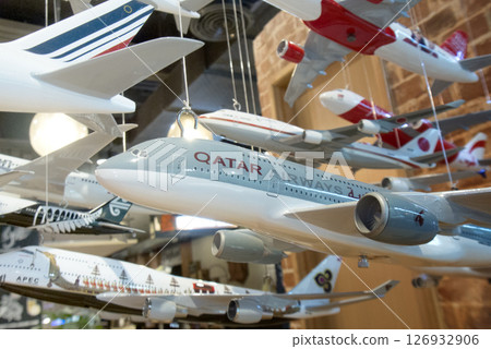 Close-up of collection of model airplanes hanging from the ceiling for decorate in a cafe. 126932906