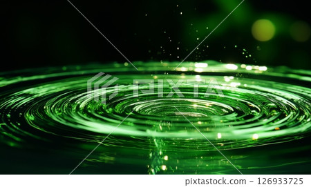 Concentric circles formed by water droplet on phosphorescent surface in close up view 126933725