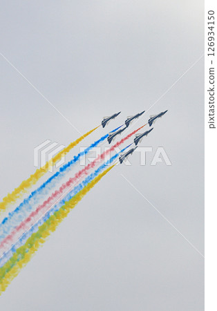 J-10 Acrobatic airshow team from China Air Force on formations with colorful smokes venting from the plane. 126934150
