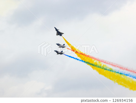 J-10 Acrobatic airshow team from China Air Force on formations with colorful smokes venting from the plane. J-10 Acrobatic airshow team from China Air Force on formations with colorful smokes venting from the plane. 126934156