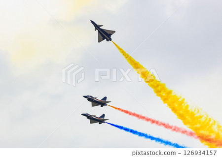 J-10 Acrobatic airshow team from China Air Force on formations with colorful smokes venting from the plane. J-10 Acrobatic airshow team from China Air Force on formations with colorful smokes venting from the plane. 126934157