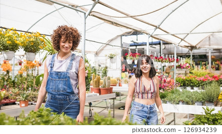 Two happy women choosing plants in a greenhouse 126934239