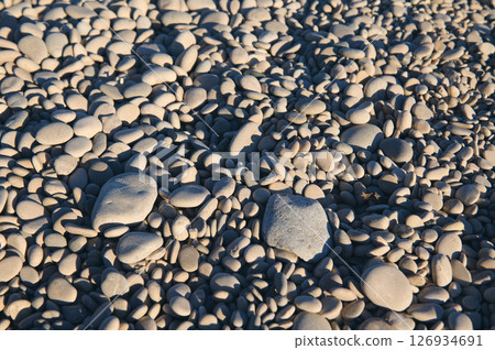 Pea-Sized Pebbles On A Sunlit Beach with Natural Light and Texture Details Pea-Sized Pebbles On A Sunlit Beach with Natural Light and Texture Details 126934691