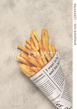 Fried French fries in a paper bag, on an abstract background, without people, in a rustic style, 126934768
