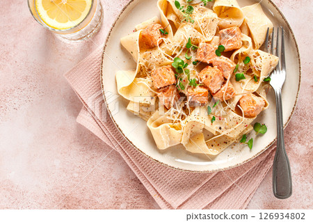 tagliatelli pasta, with salmon slices and herbs, on a decorative plate, homemade, no people 126934802