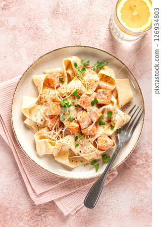 tagliatelli pasta, with salmon slices and herbs, on a decorative plate, homemade, no people 126934803