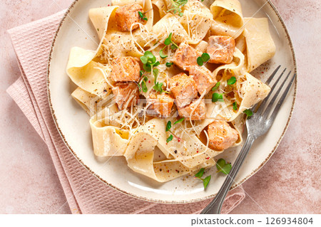 tagliatelli pasta, with salmon slices and herbs, on a decorative plate, homemade, no people 126934804