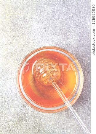 spoon with honey, on the table, spindle for honey, close-up, rustic view, spoon with honey, on the table, spindle for honey, close-up, rustic view, 126935086