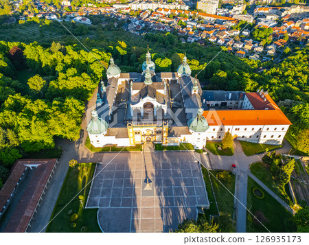 Perched above the town of Pribram, the Baroque complex of Holy Mountain serves as a significant pilgrimage destination surrounded by lush greenery and historical architecture. Perched above the town of Pribram, the Baroque complex of Holy Mountain serves as a significant pilgrimage destination surrounded by lush greenery and historical architecture. 126935173