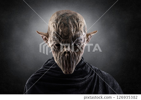 Portrait of a creepy monster over dark misty background Portrait of a creepy monster over dark misty background 126935382
