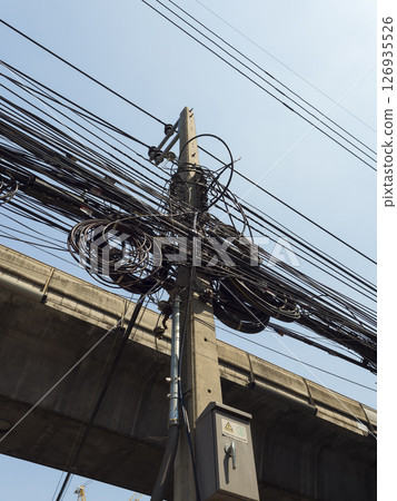Bangkok, Thailand A telephone pole densely packed with electric wires 126935526