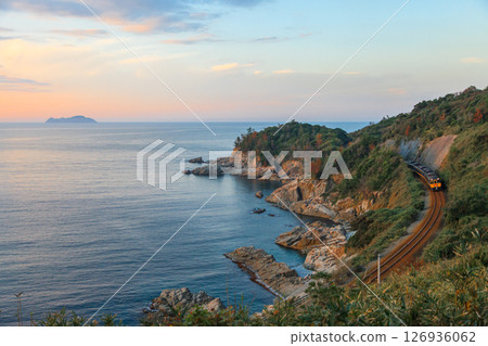 A magnificent view of the San'in Main Line running along the Sea of Japan in the evening calm 126936062