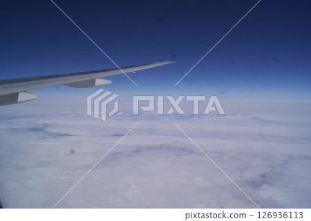 Sea of clouds and the scenery seen from an airplane window Sea of clouds and the scenery seen from an airplane window 126936113