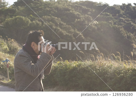 A man holding a camera 126936280