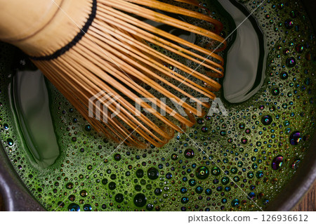 Matcha Whisking. Elegant matcha tea setup with whisk Matcha Whisking. Elegant matcha tea setup with whisk 126936612