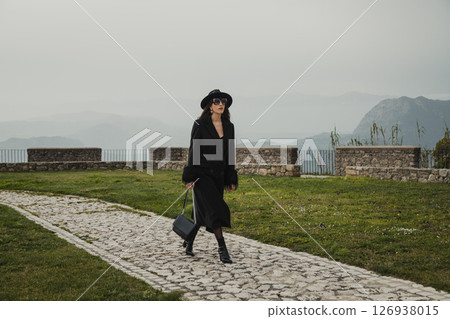 Elegant Woman Walking On The Stone Path Inside The Square Near The Castle 126938015