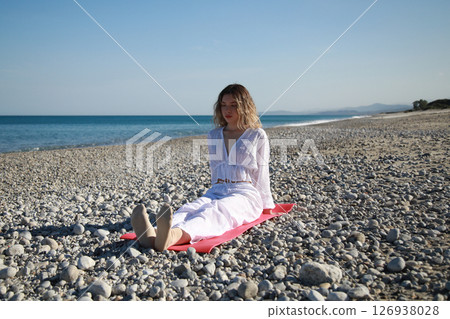 Young Woman Trains Her Feet Before Dancing on the Beach Near the Sea Young Woman Trains Her Feet Before Dancing on the Beach Near the Sea 126938028